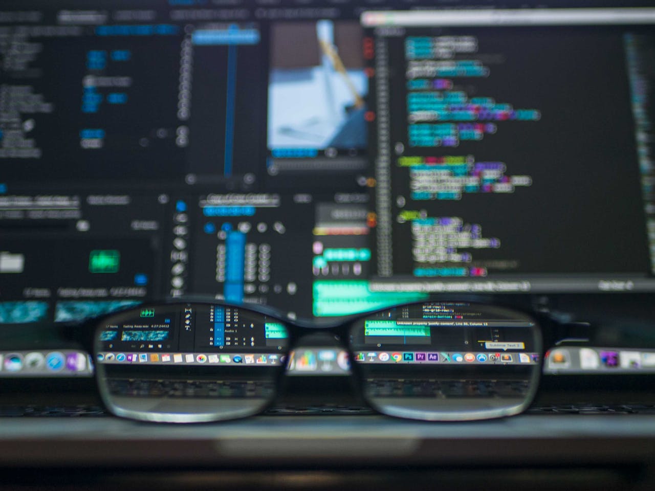 brand-02 Eyeglasses reflecting computer code on a monitor, ideal for technology and programming themes.
